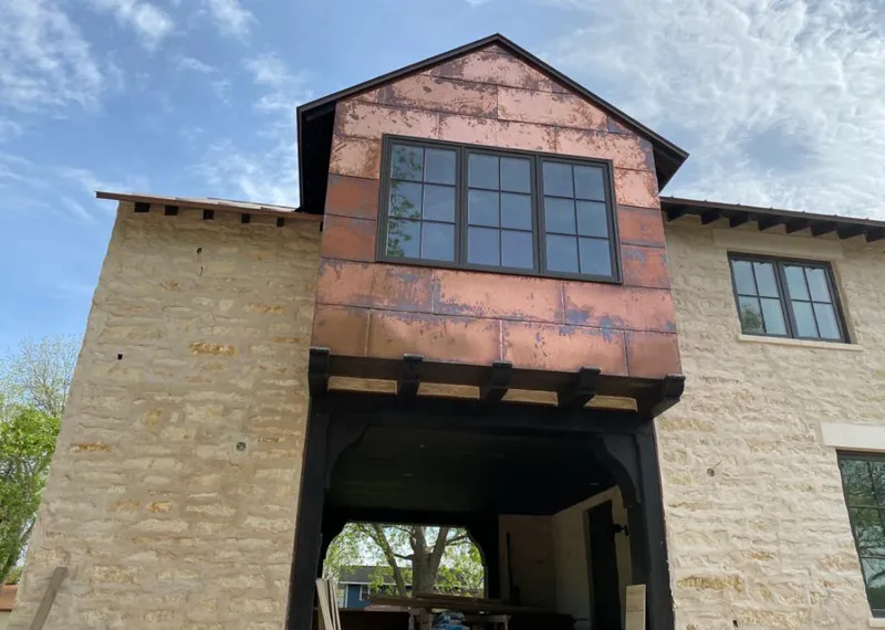 Copper metal panel facade on a stone building for Skylight Installation in Villa Rica