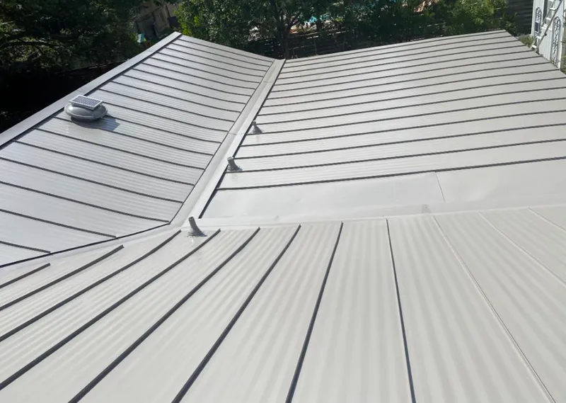 Solar attic fan installed on a metal roof for Roof Ventilation in Villa Rica